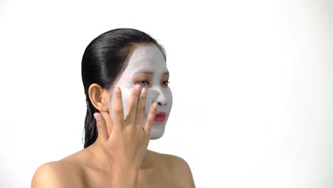 Young-woman-clay-face-mask-peeling-natural-with-purifying-mask-on-her-face-on-white-background