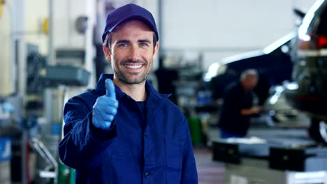 Portrait-of-a-young-beautiful-car-mechanic-in-a-car-workshop,-in-the-background-of-service.-Concept:-repair-of-machines,-fault-diagnosis,-repair-specialist,-technical-maintenance-and-on-board-computer