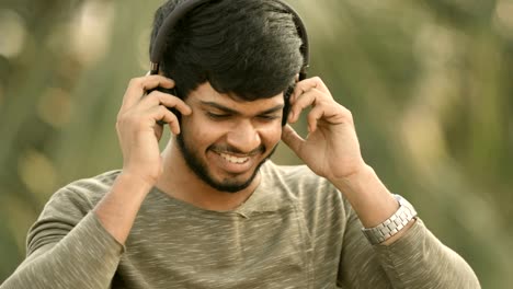 Young-man-enjoying-music-in-headphone