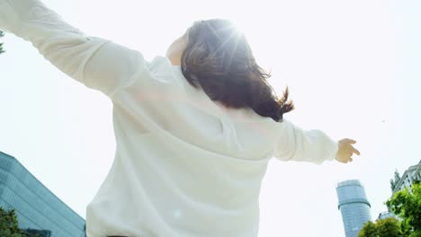 Portrait-of-Asian-Chinese-female-executive-celebrating-outdoors