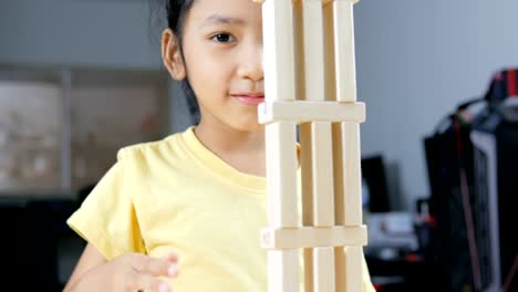 Close-up-shot-Asian-little-girl-playing-wooden-brick-toy