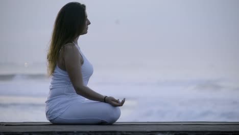 Calm-Woman-Meditating-on-Coastline