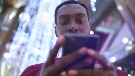 African-American-Man-using-business-app-on-smart-phone