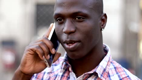 attractive-black-african-man-talking-by-phone---outdoor