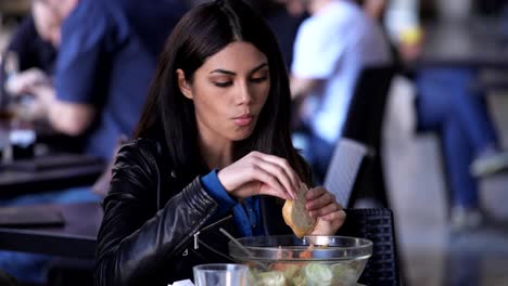 thoughtful-beautiful-asian-woman-eatig-salad-in-a-cafe