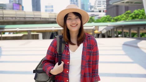 Attractive-young-smiling-Asian-woman-outdoors-portrait-in-the-city-real-people-series.-Outdoors-lifestyle-fashion-portrait-of-happy-smiling-Asian-girl.-Summer-outdoor-happiness-portrait-concept.