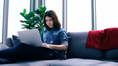 beautiful-smart-asian-woman-relax-time-with-laptop-shop-online-in-living-room-house-background