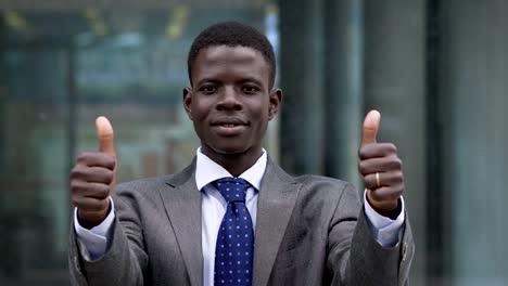 Success,winning.-Young-american-african-man-making-thumbs-up--outdoor