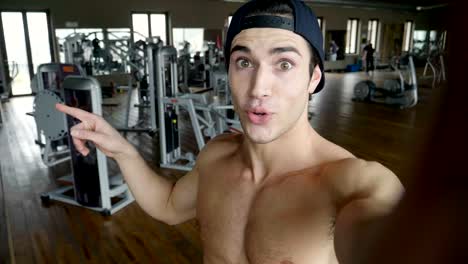 A-boy-during-a-break-from-training-takes-a-picture-in-the-gym-to-send-to-friends-or-girlfriend-or-to-post-on-social-networks.