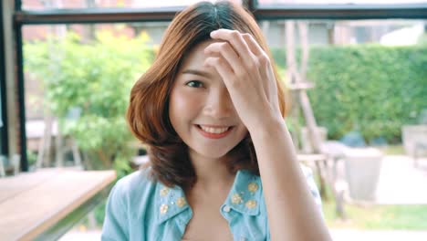 Portrait-of-Beautiful-young-asian-brunette-woman-smiling-while-standing-in-cafe.-Women-lifestyle-concept.