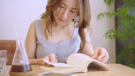 Young-Chinese-Student-with-books-In-the-library