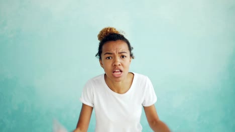 Portrait-of-screaming-mixed-race-woman-talking-and-gesturing-expressing-negative-emotions-then-walking-away-angry-and-offended.-Feelings-and-people-concept.