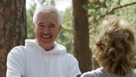 Elderly-Fitness-Instructor-Smiling-for-Camera-in-Park