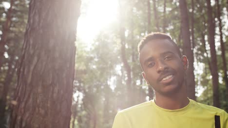 Confident-Man-Posing-in-Forest-on-Sunny-Day