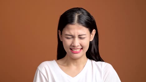 Angry-woman-isolated.-Portrait-of-asian-woman-in-white-t-shirt-screaming-out-loud-looking-at-camera.