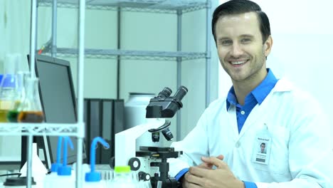 Portraits-of-scientist-male-is-looking-through-microscope-and-working-in-modern-laboratory-or-medical-center.-Concept-of-science,-testing-development-and-lab-industry.