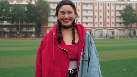 Asian-college-girl-smile-at-camera-in-campus-slow-motion