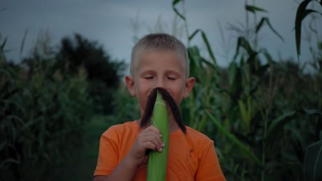 A-boy-with-corn-silk-mustache.-Boy-making-a-mustache-from-corn-hair