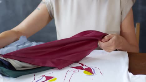 Woman-Choosing-Fabric-to-Decorate-Hand-painted-T-Shirt