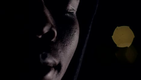 Depressed-thoughtful-african-man-in-the-darkness-opening-his-eyes