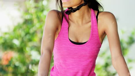 Portrait-young-ethnic-girl-keep-fit-cycling-outdoors