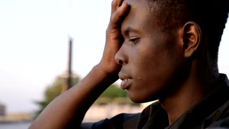 Worried-pensive-black-african-man-outdoor--profile