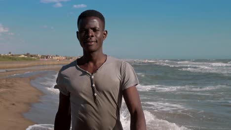 Confident-proud-handsome-blac-african-man-walking-on-the-beach--slow-motion