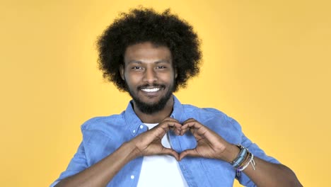 Handmade-Heart-by-Afro-American-Man-on-Yellow-Background