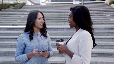 Two-successful-women-talking-during-coffee-break