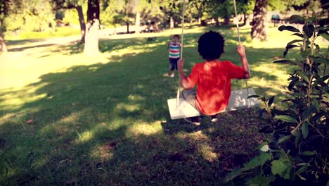 Happy-little-boy-on-a-swing