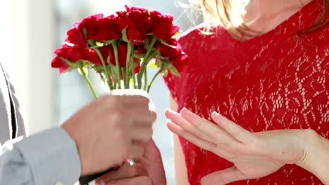 Man-offering-flowers-and-engagement-ring