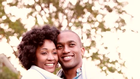 Smiling-young-couple-embracing-romantically