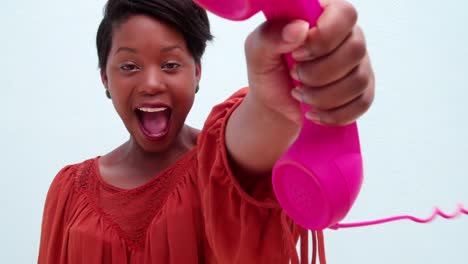 Happy-Young-Woman-holding-pink-telephone