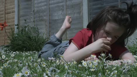 Cute-child-eating-apple-in-the-grass-barefoot