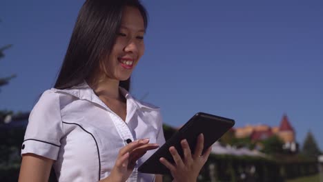 successful-businesswoman-wearing-in-elegant-shirt-with-gadget-outdoors