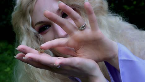 4k-Fantasy-Shot-of-a-Fairy-Holding-a-Tiny-Frog-in-hands