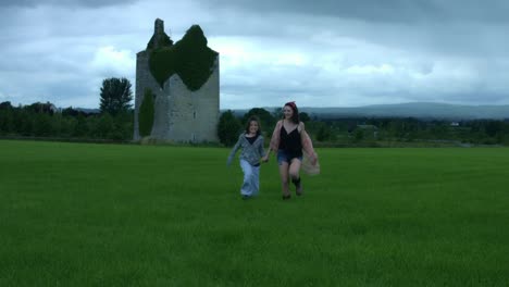 4k-Castle-in-Background-Shot-of-a-Woman-and-her-Son-running