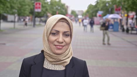 Confident-middle-adult-Arab-woman-walking-down-street