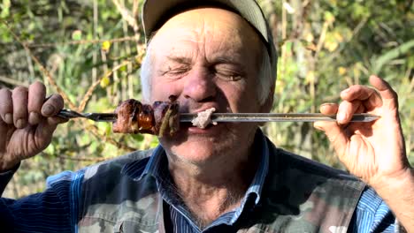 An-elderly-man-eating-fried-meat
