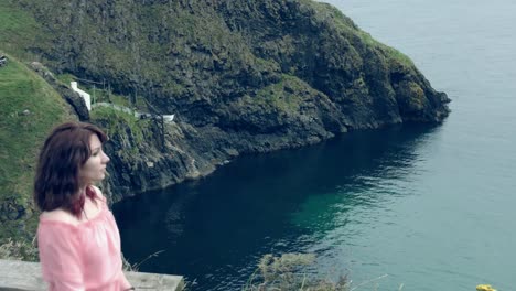 4k-Shot-of-a-Woman-posing-on-a-Sea-and-Coast-Background