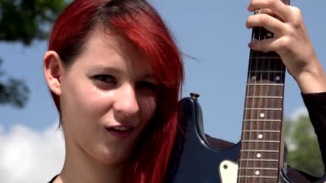 Mujer-pelirroja-posando-con-guitarra