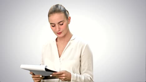 Young-businesswoman-reading-documents-on-white-background