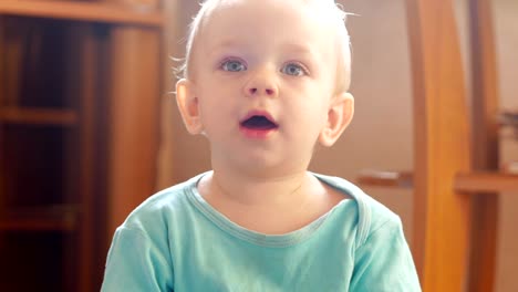 Attractive-boy-2-years-of-playing-at-home-with-a-plastic-duck.-The-kid-talks-to-his-parents.-Close-up