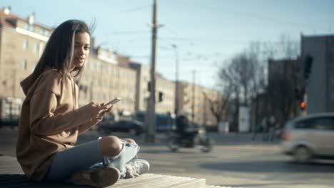 Portrait-of-young-African-American-woman-using-phone,-outdoors.