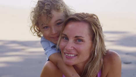 Portrait-of-mother-and-young-son-at-beach.