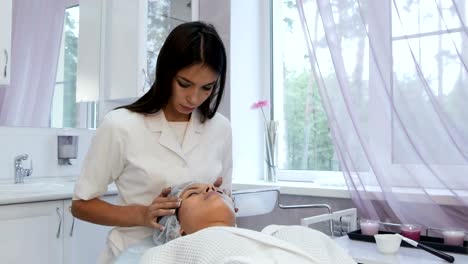 Beautiful-young-girl-having-face-massage-in-spa-salon