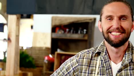 Portrait-of-smiling-male-staff-standing-at-bakery-section