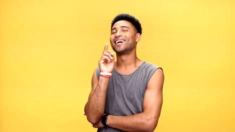 Young-happy-african-man-have-an-idea-over-yellow-background.