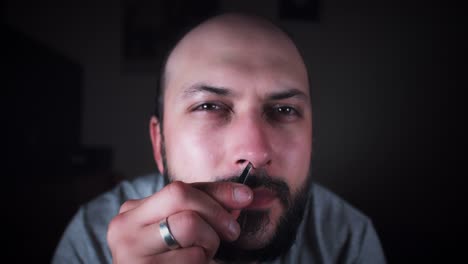 4K-Man-Looking-in-Mirror-and-Picking-Nose-Hair