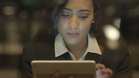 Young-Attractive-Black-Women-Using-Tablet-Computer-Searching-the-Web-Online.-African-American-Female-in-Business-Suit-Connecting-with-Social-Media.-Urban-Lifestyle-Background